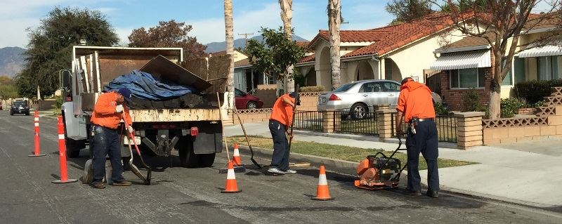 Construction Workers filling in potholes