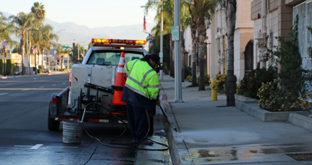 Construction worker street sweeping